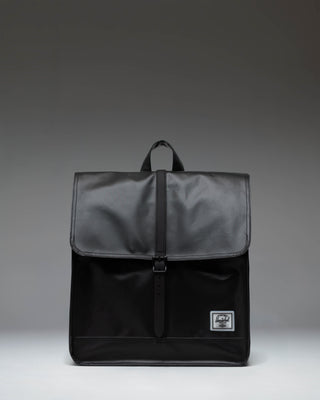 Herschel Supply Co. City Backpack in black, showing the clean, minimalist design with a single strap closure on the front pocket.