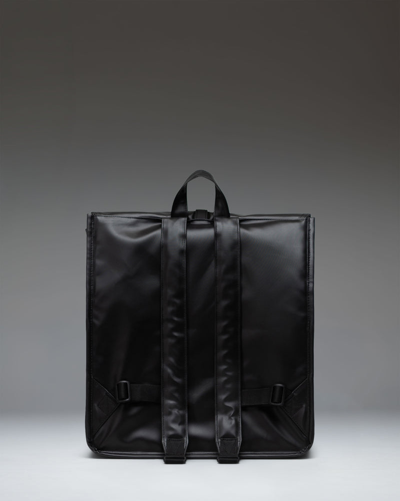 Herschel Supply Co. City Backpack in black, shown from the side to highlight its slim profile, adjustable shoulder strap, and classic design.