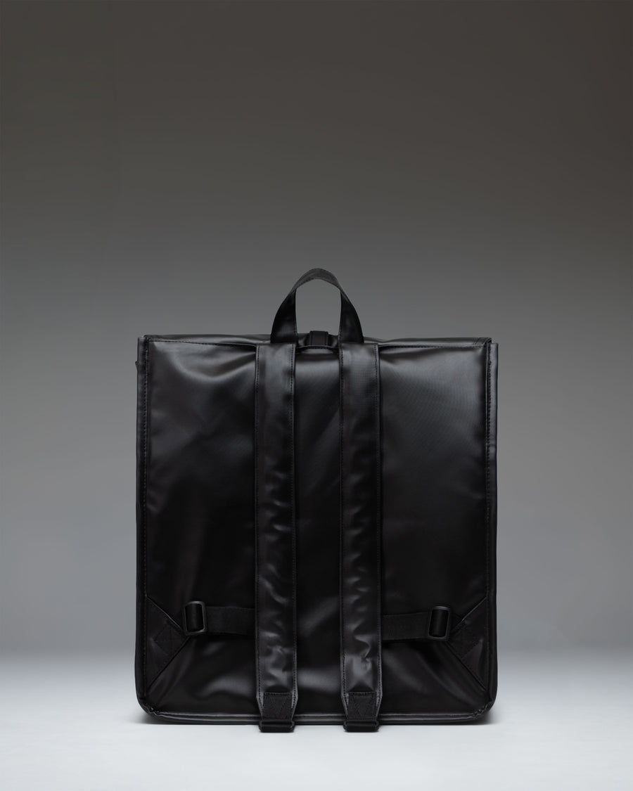 Herschel Supply Co. City Backpack in black, shown from the side to highlight its slim profile, adjustable shoulder strap, and classic design.