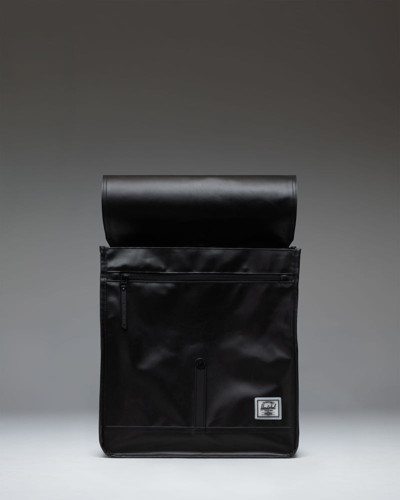 Herschel Supply Co. City Backpack in black, featuring a slim design with a single front strap closure and classic woven label.