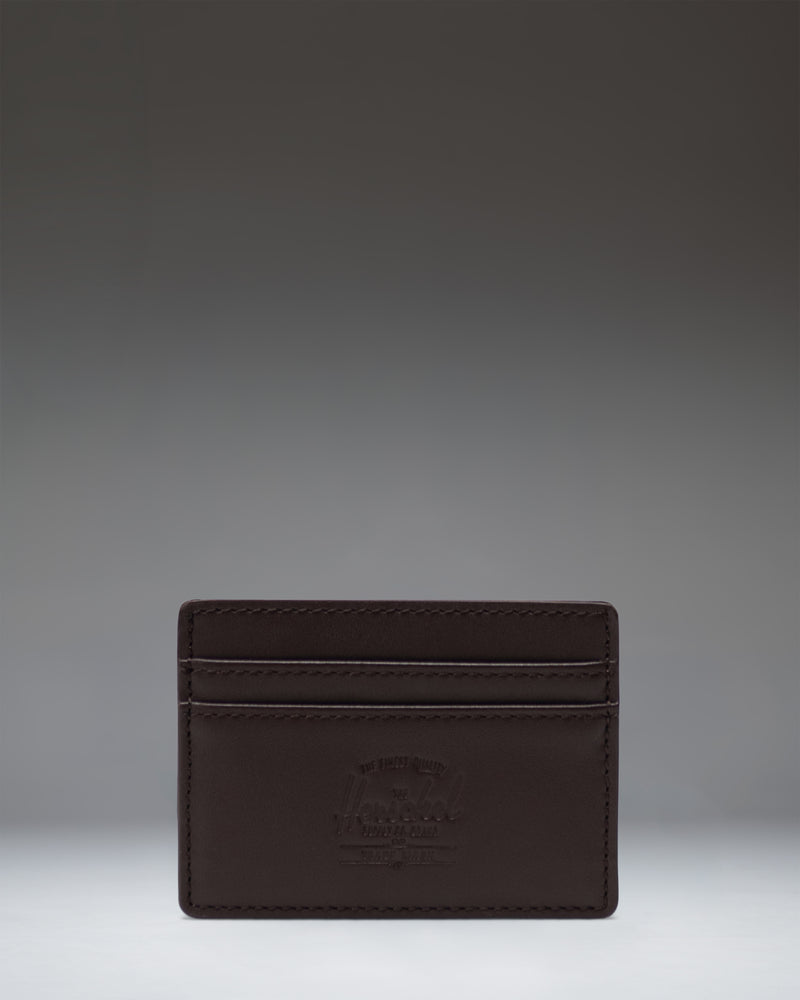 Brown leather Herschel Supply Co. Charlie Cardholder featuring multiple card slots and the classic woven logo label.