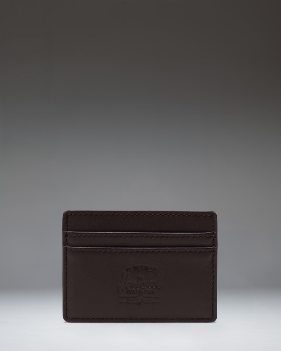 Brown leather Herschel Supply Co. Charlie Cardholder featuring multiple card slots and the classic woven logo label.