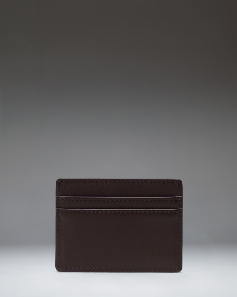 Brown leather Herschel Supply Co. Charlie Cardholder featuring multiple card slots, a top storage sleeve, and a classic woven logo label.
