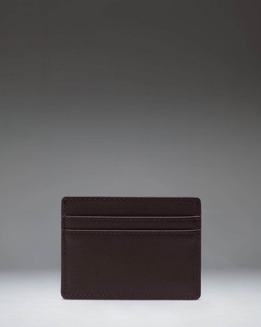 Brown leather Herschel Supply Co. Charlie Cardholder featuring multiple card slots, a top storage sleeve, and a classic woven logo label.