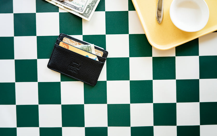 Herschel Supply Co. Charlie Cardholder in Black vegan leather, featuring a slim design with multiple card slots and a classic logo label.