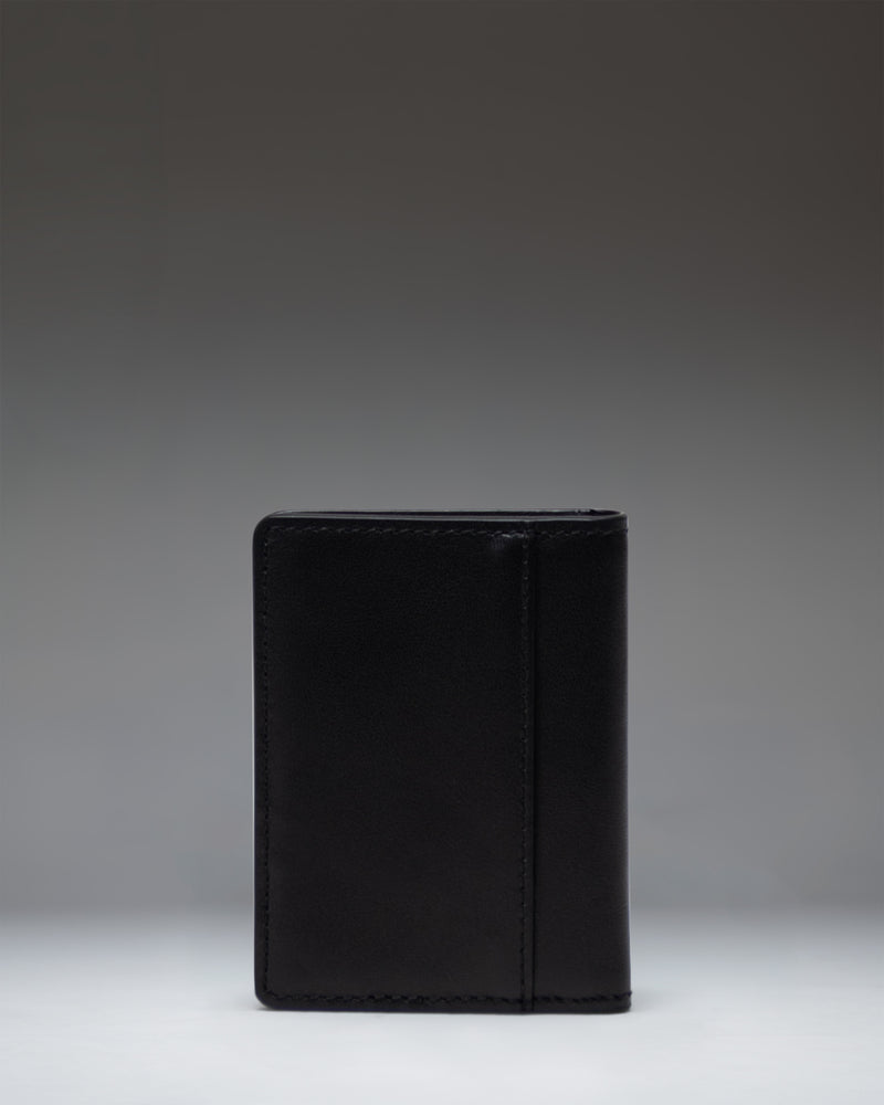 Herschel Supply Co. black leather Gordon Wallet shown from an overhead perspective, opened flat to display the internal card slots and compartments.
