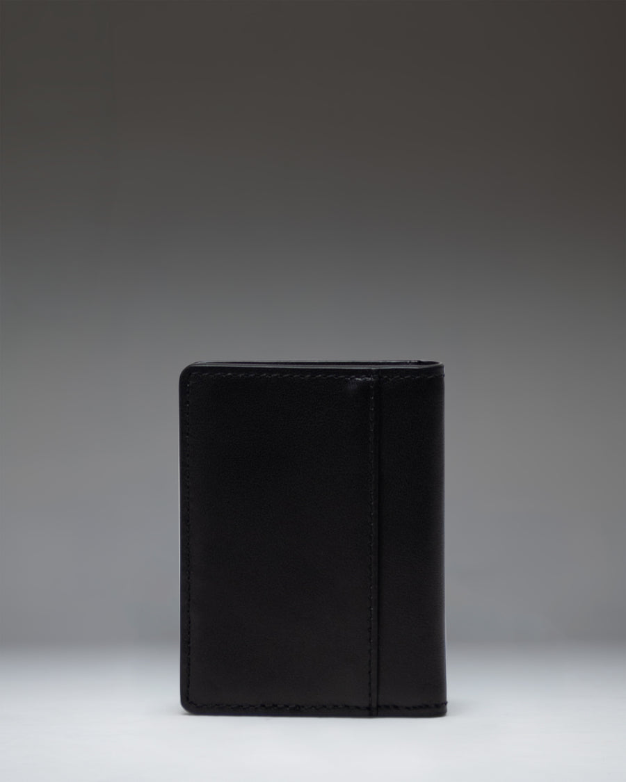 Herschel Supply Co. black leather Gordon Wallet shown from an overhead perspective, opened flat to display the internal card slots and compartments.