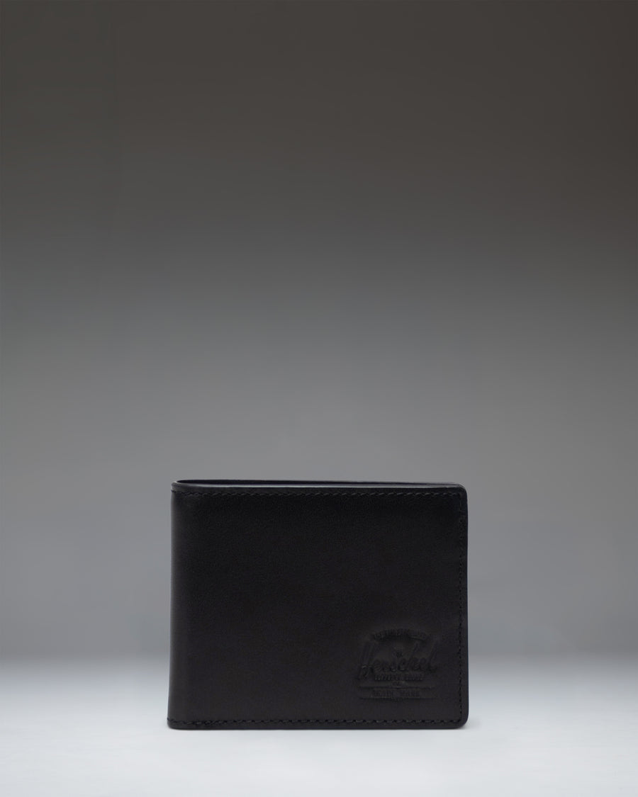 Herschel Supply Co Hank Wallet Leather in Black, shown opened to display internal card slots and a mesh ID window.