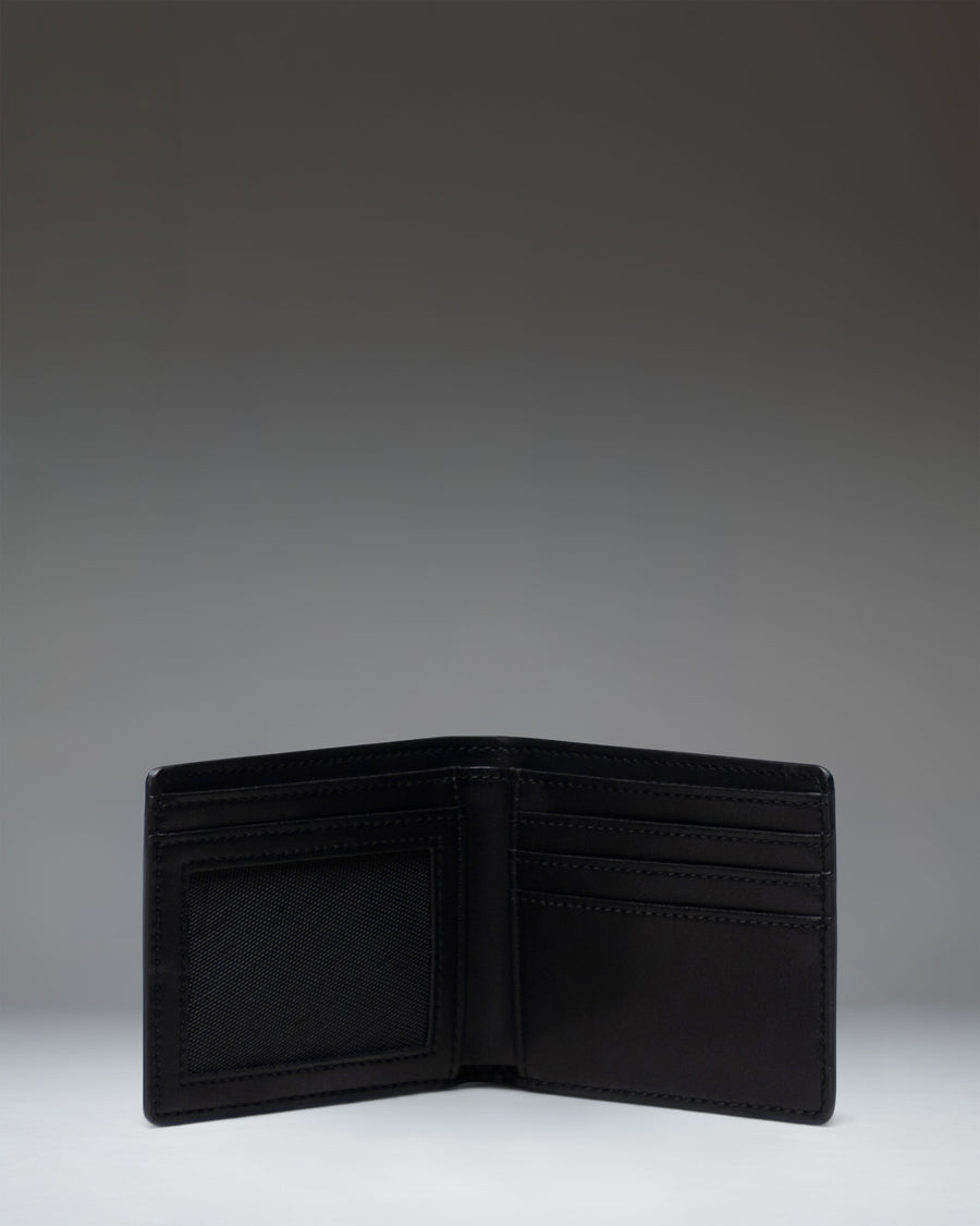 Herschel Supply Co. Hank Wallet Leather in Black, shown open to reveal interior card slots and a mesh ID window.