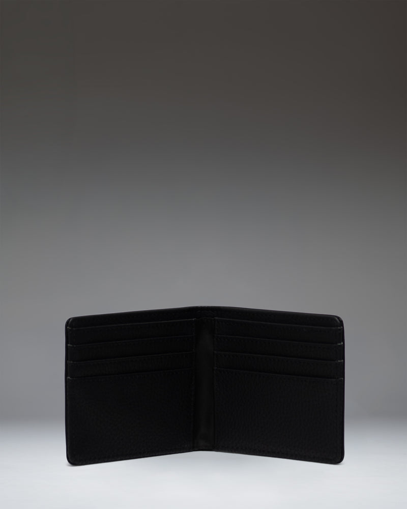 Open interior view of the Herschel Supply Co. Roy Wallet in black vegan leather, displaying card slots and bill compartment.