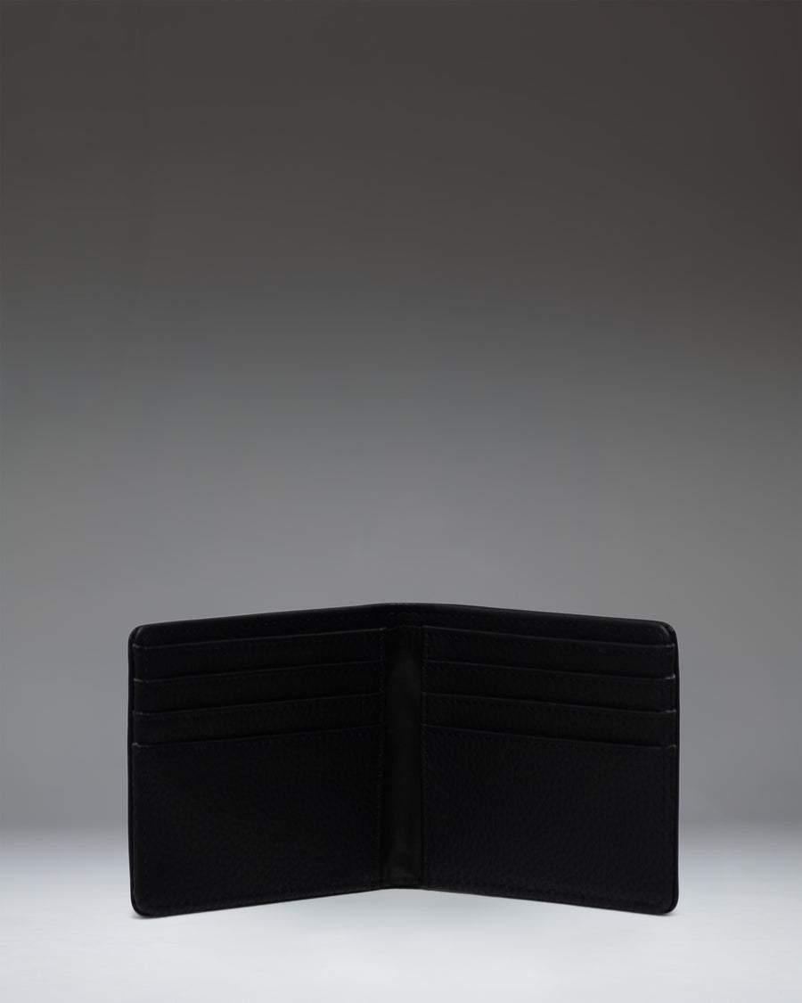 Open interior view of the Herschel Supply Co. Roy Wallet in black vegan leather, displaying card slots and bill compartment.
