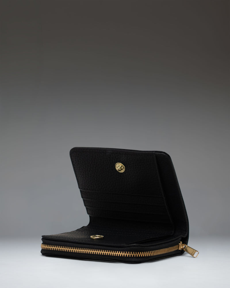 Herschel Supply Co. Georgia Wallet in black vegan leather shown from an angled front view, displaying its textured finish and classic design.