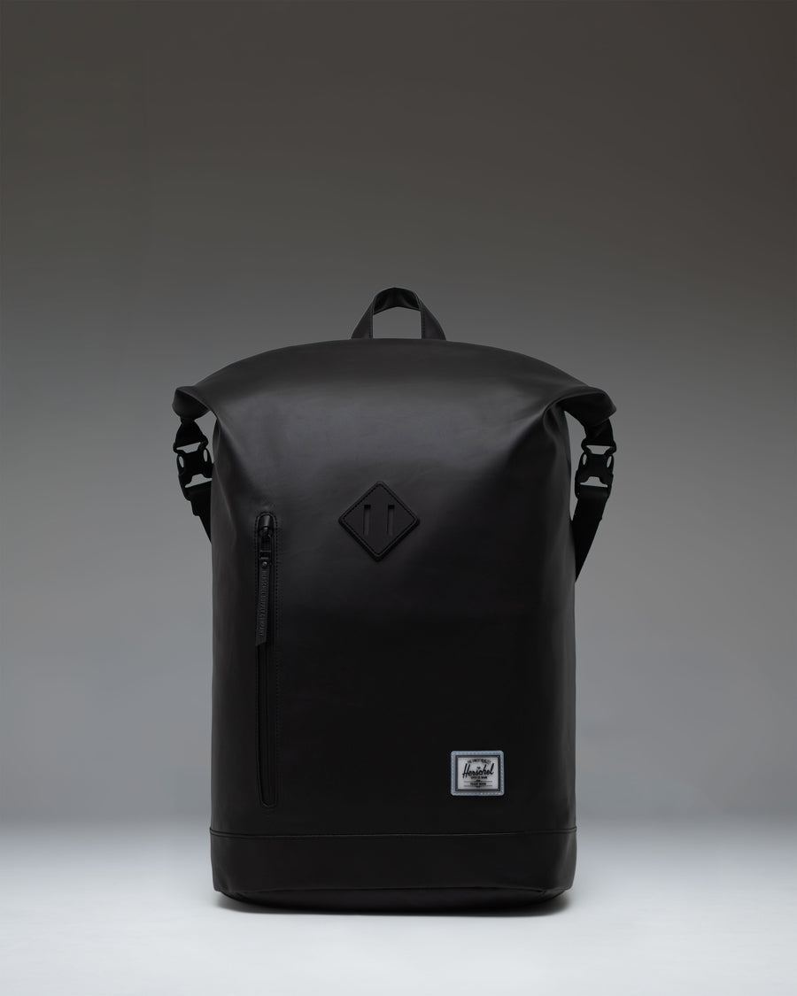 Black Herschel Supply Co. Roll Top Backpack shown from the front, highlighting its roll-top closure and clean, minimalist design.