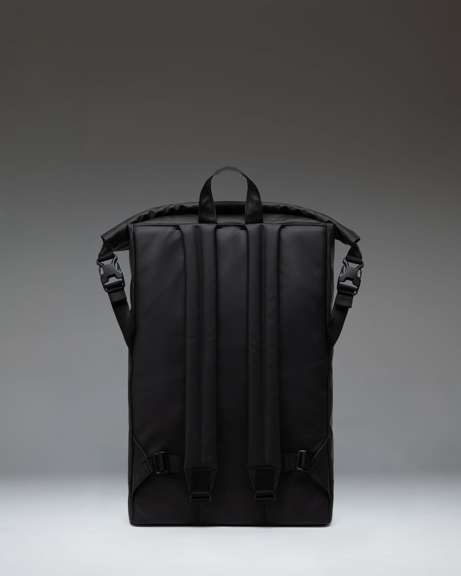 Herschel Supply Co. Roll Top Backpack in solid black, showcasing a clean, modern design with a rolled top closure and buckle fastening.