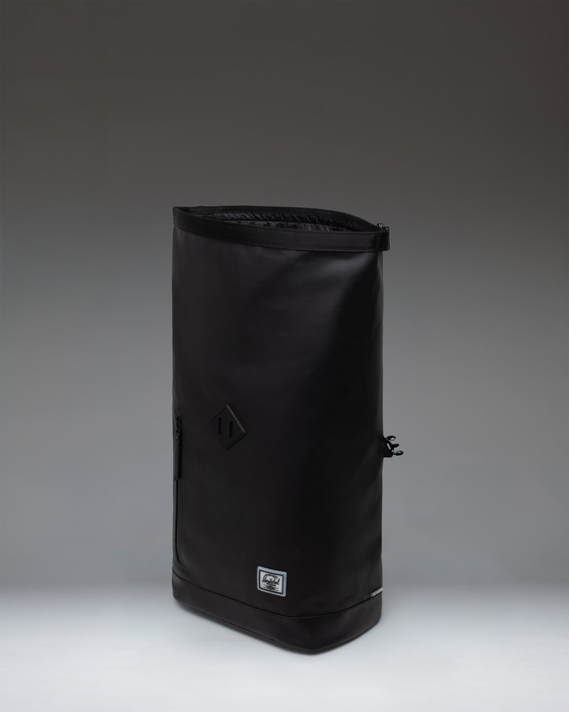 Herschel Supply Co. Roll Top Backpack in black, showing the clean, rolled-top design and durable material.