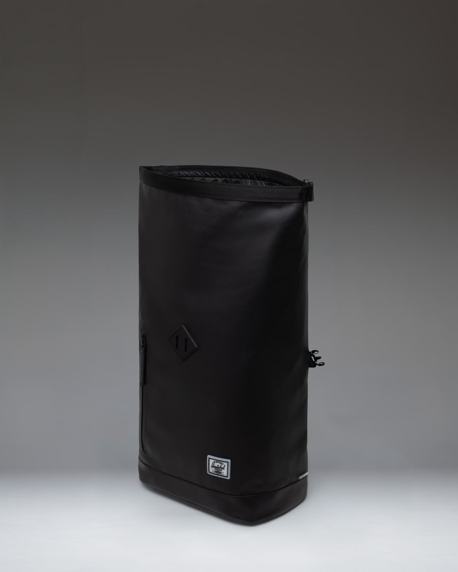 Herschel Supply Co. Roll Top Backpack in black, showing the clean, rolled-top design and durable material.
