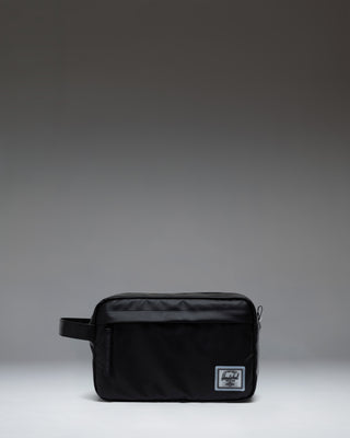 Herschel Supply Co. Chapter Travel Kit in black, featuring a convenient side handle and a front zippered storage pocket.