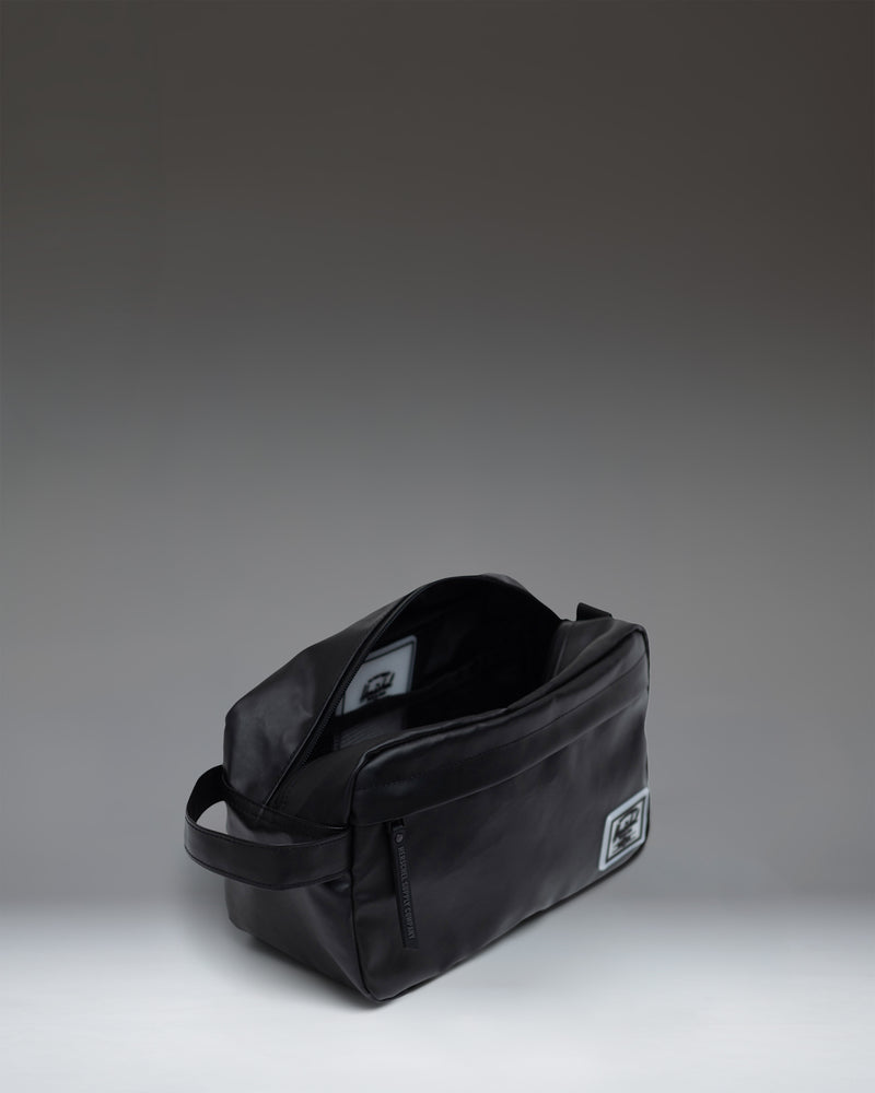 Herschel Supply Co. Chapter Travel Kit in classic black, featuring a convenient side handle and zippered main compartment.