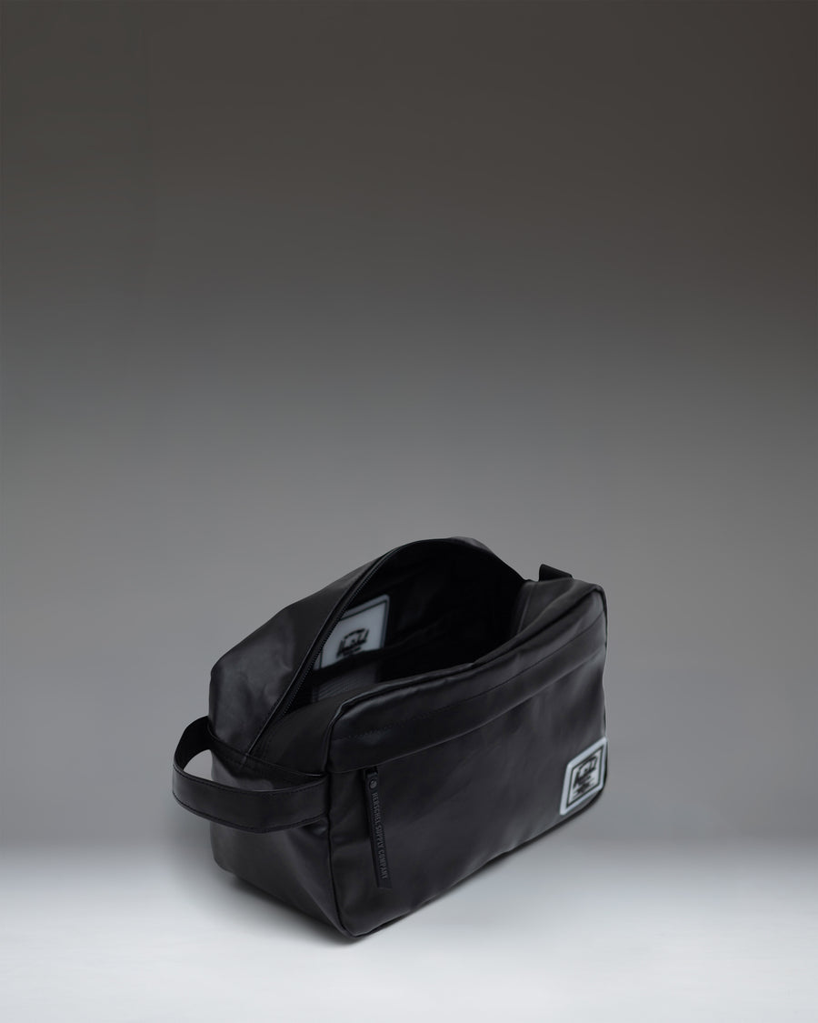 Herschel Supply Co. Chapter Travel Kit in classic black, featuring a convenient side handle and zippered main compartment.