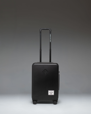 Black Herschel Heritage Hardshell Large CarryOn Luggage shown from the front against a white background.