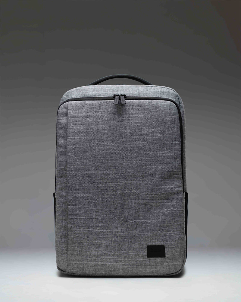 Herschel Supply Co. Kaslo Backpack Tech in Raven Crosshatch, showing a detailed view of the front pockets and textured grey fabric.