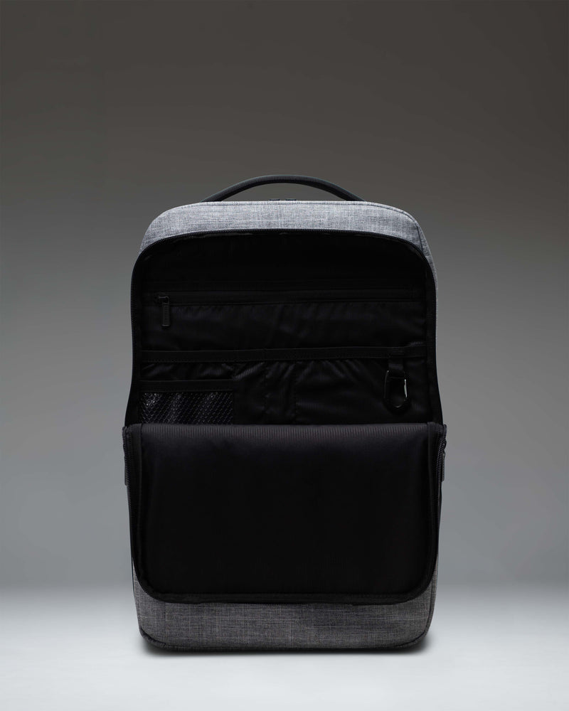 Herschel Supply Co. Kaslo Backpack Tech in Raven Crosshatch grey, showing a detailed view of the front storage compartment and straps.