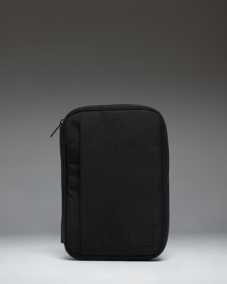 Black Herschel Supply Co. Burrard Organizer Tech pouch, front view showing the clean exterior design and classic woven label.