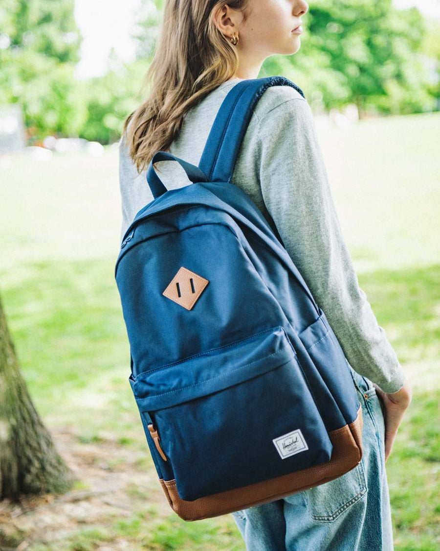 Herschel Heritage Backpack color options including black, grey, navy, red, olive, and pink displayed in a grid.
