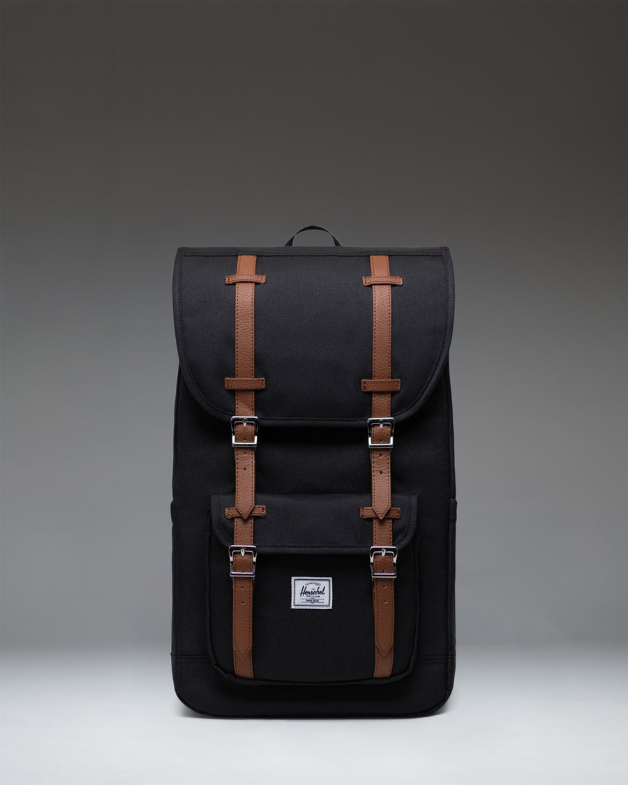 Herschel Supply Co. Little America Backpack in black, featuring a classic mountaineering style with dual rubber straps and a front pocket.