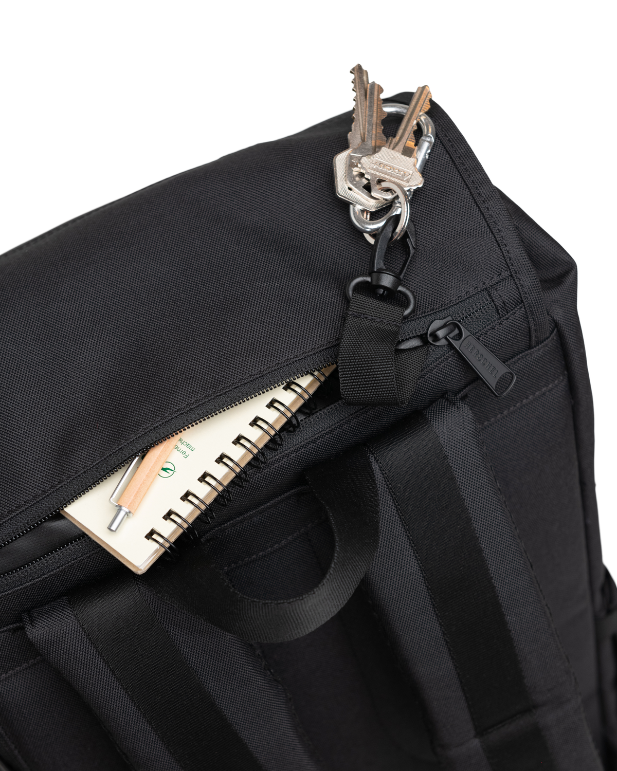 Herschel Supply Co. x Realtree limited-edition collection essential bags, apparel, and accessories arranged together in the APX camouflage pattern.