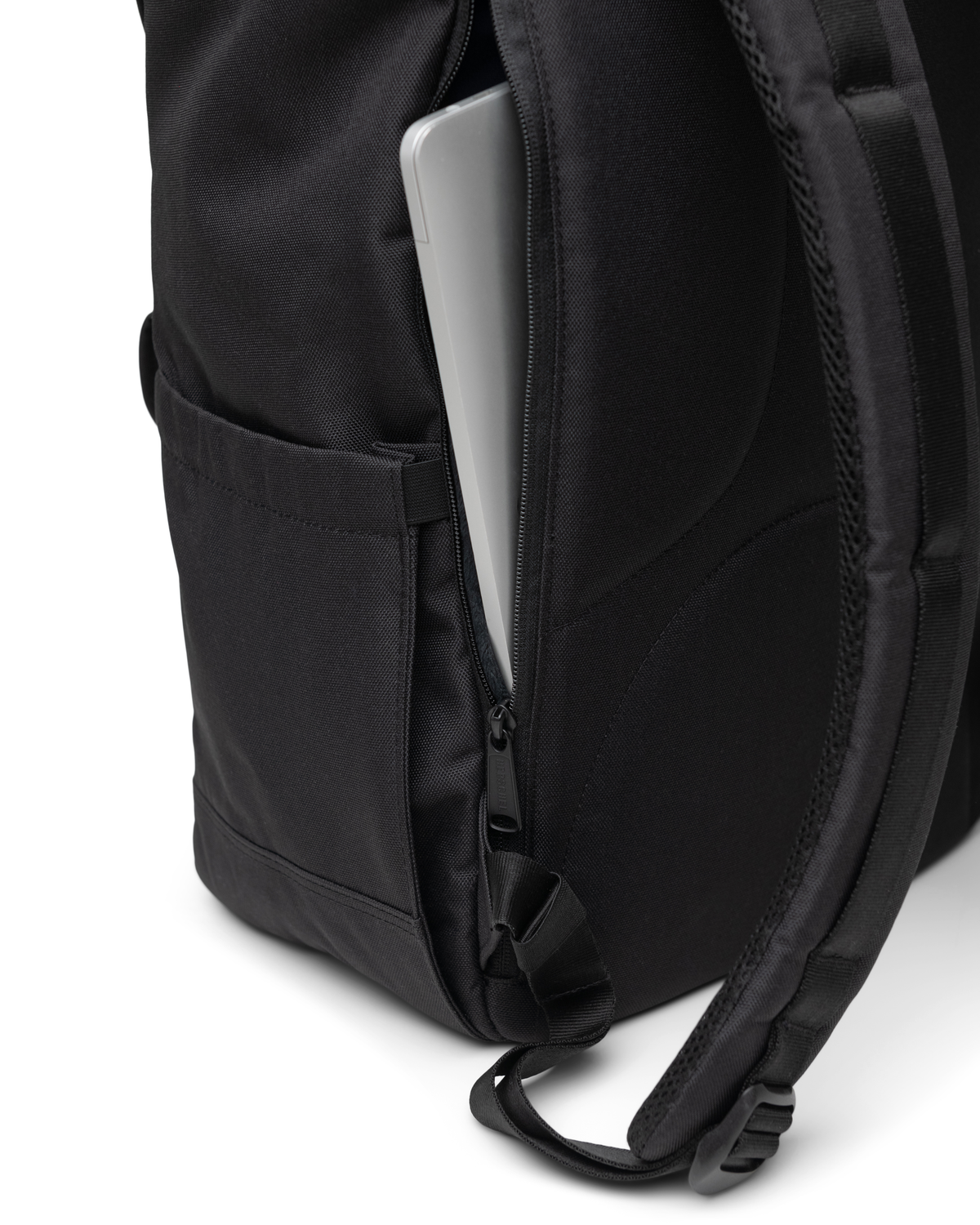 Close-up of the Herschel Little America Backpack detailing its magnetic strap closures and durable fabric construction.