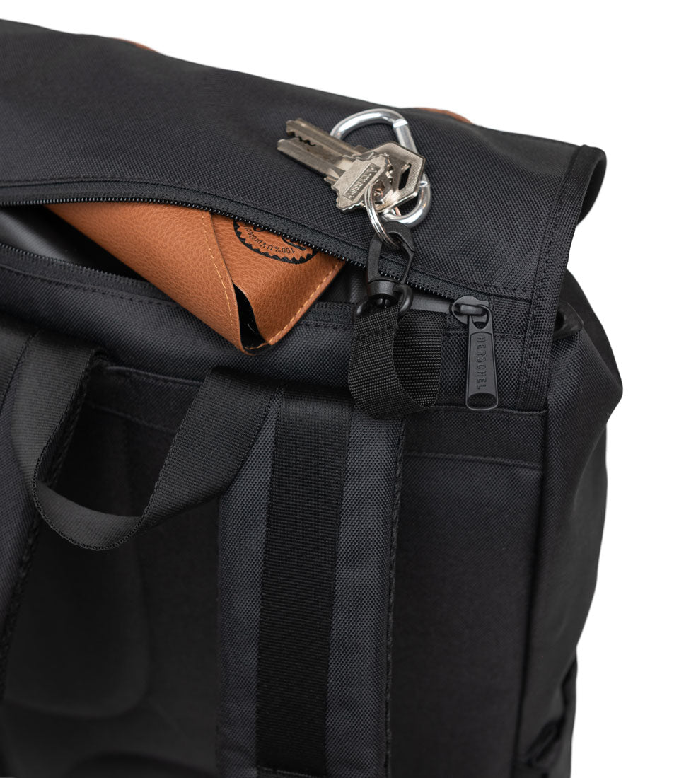 Herschel Supply Co. x Realtree limited-edition collection essential bags, apparel, and accessories arranged together in the APX camouflage pattern.