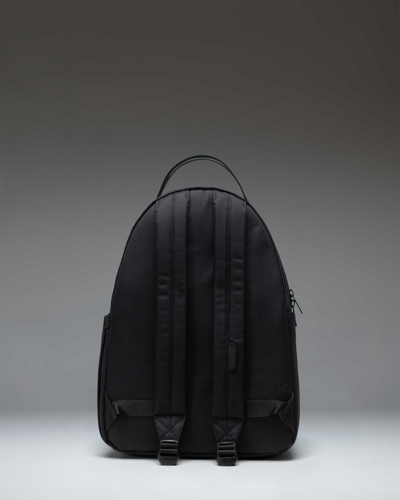 Herschel Nova Backpack in Black Tonal, showing a front view of the minimalist, sleek black backpack with dual top carrying handles.