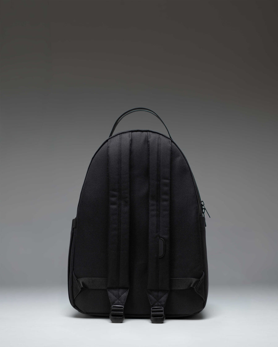 Herschel Nova Backpack in Black Tonal, showing a front view of the minimalist, sleek black backpack with dual top carrying handles.