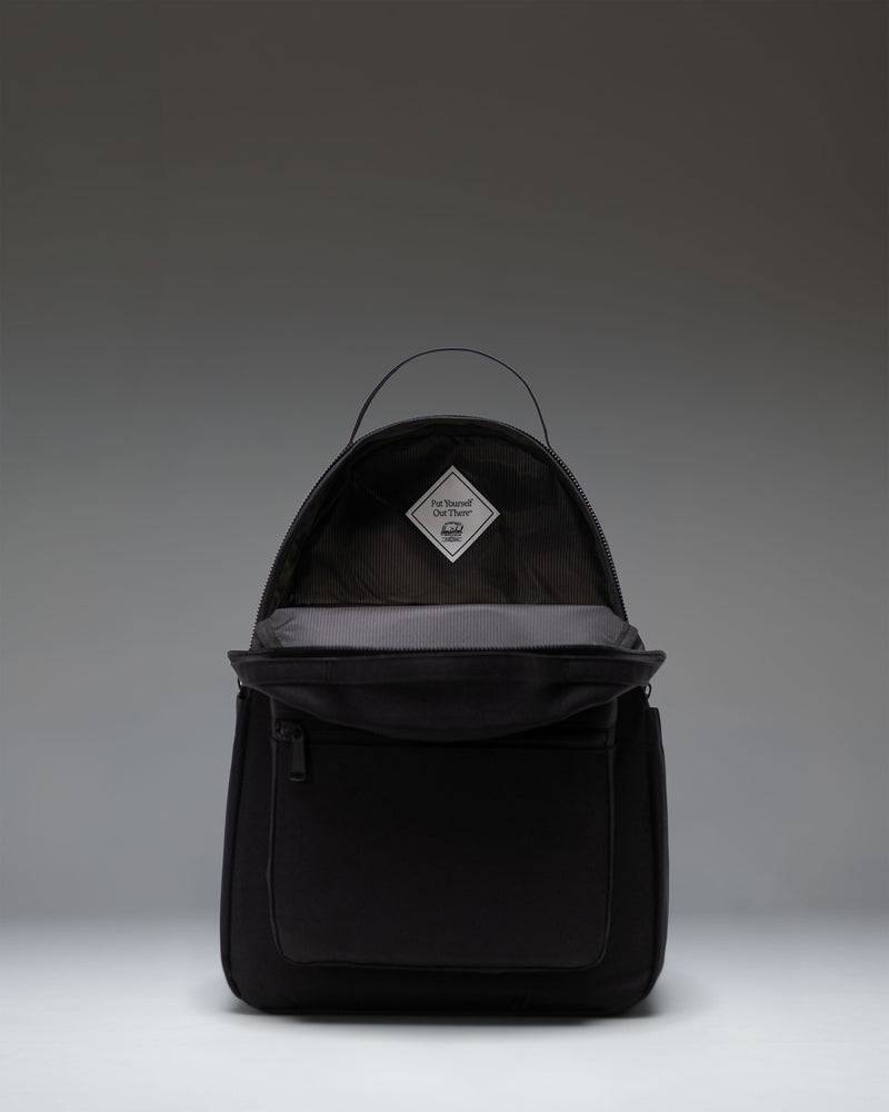 Herschel Nova Backpack in Black Tonal, showing a close-up of the front storage pocket, dual top carrying handles, and signature fabric liner.