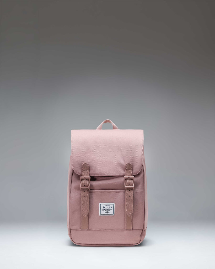 Herschel Retreat Mini Backpack in Ash Rose, a dusty pink color, featuring a drawstring closure and a single magnetic strap.