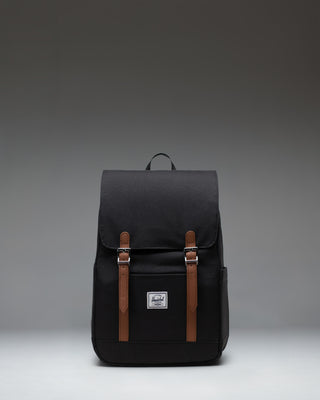 Herschel Retreat Small Backpack in black, showcasing its classic design with a single strap closure and a clean, compact silhouette.