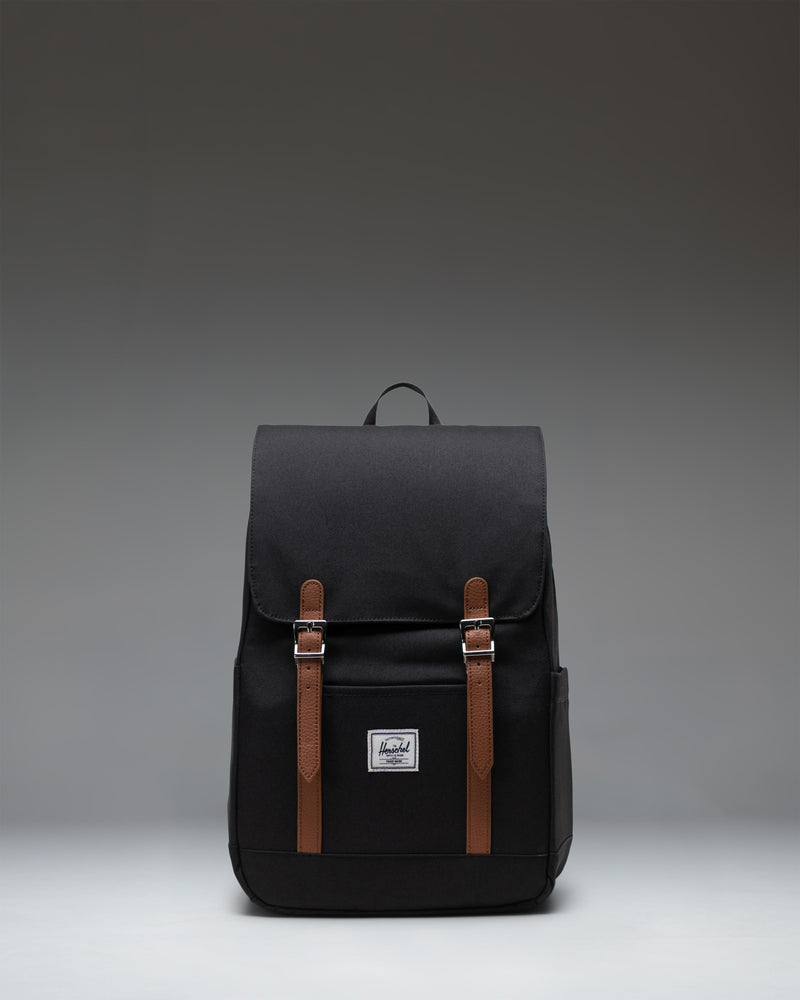 Herschel Retreat Small Backpack in black, showcasing its classic design with a single strap closure and a clean, compact silhouette.