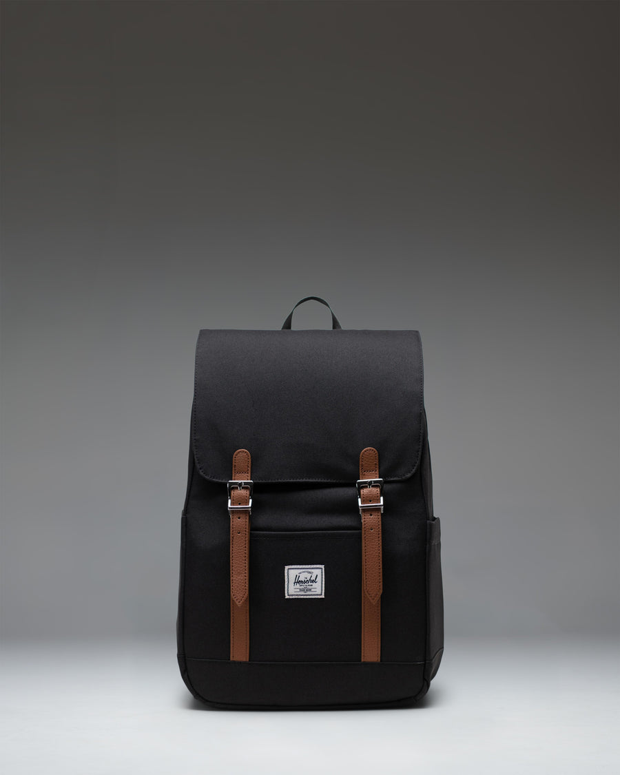 Herschel Retreat Small Backpack in black, showcasing its classic design with a single strap closure and a clean, compact silhouette.
