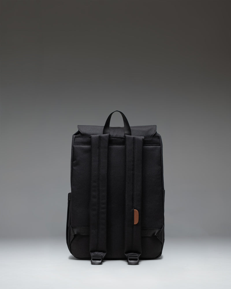 Herschel Retreat Small Backpack in black, featuring a classic silhouette, drawcord closure, and magnet-fastened straps with metal buckles.