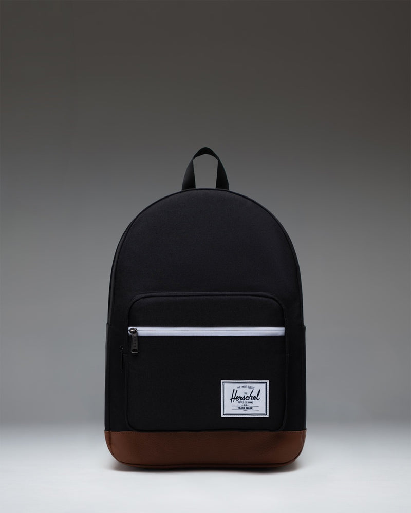 Herschel Supply Co. Pop Quiz Backpack in Black/Tan featuring a front pocket, leather accent, and signature woven label.