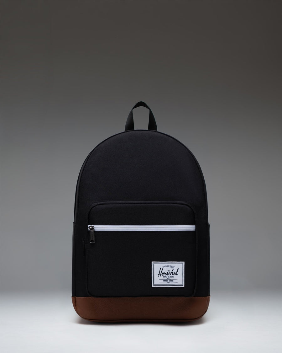 Herschel Supply Co. Pop Quiz Backpack in Black/Tan featuring a front pocket, leather accent, and signature woven label.
