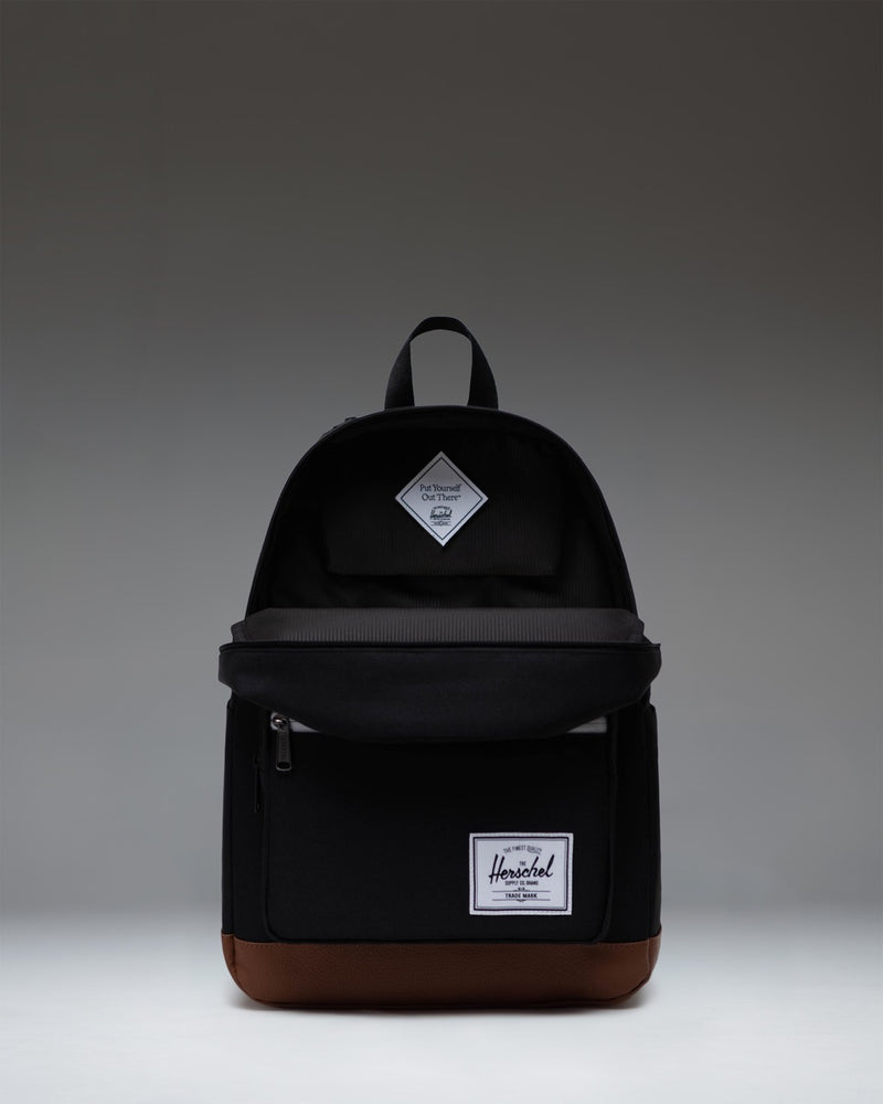 Herschel Supply Co. Pop Quiz Backpack in Black featuring a tan synthetic leather base and front pocket detailing.
