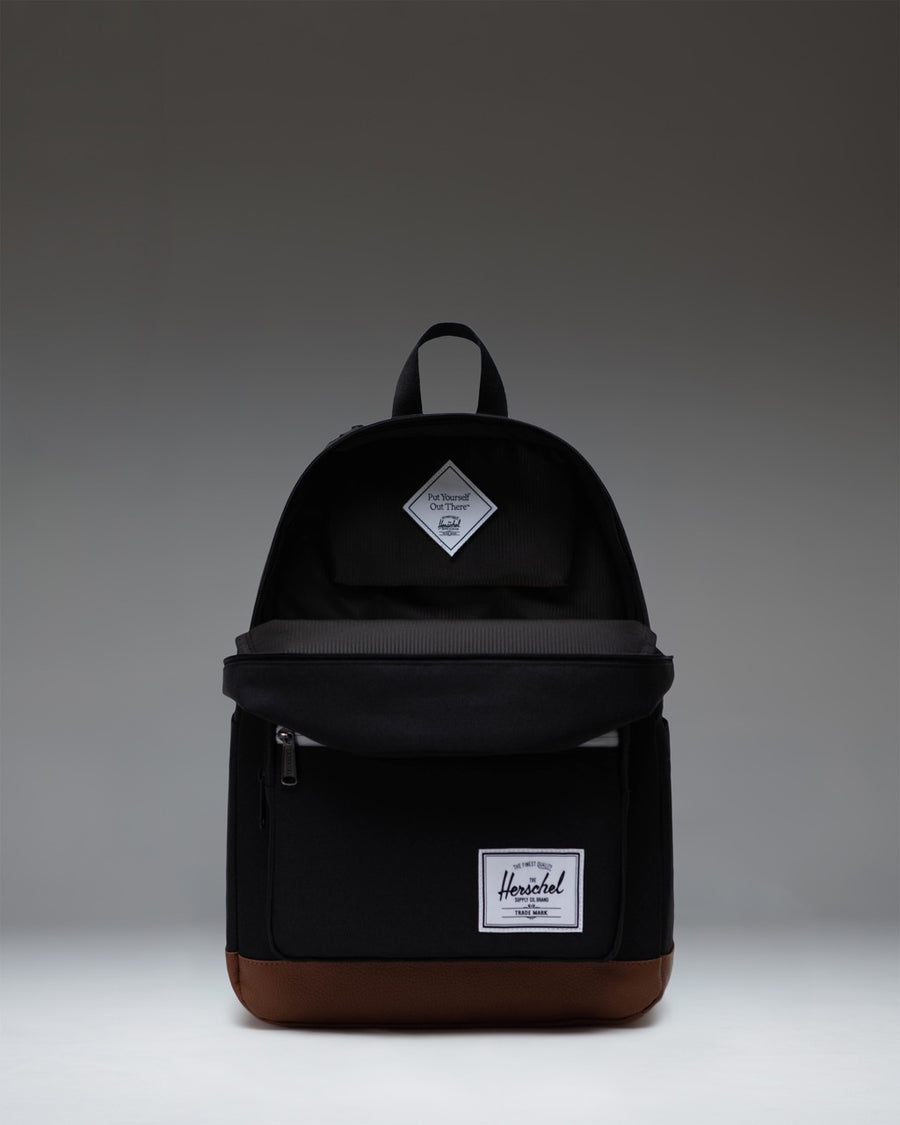Herschel Supply Co. Pop Quiz Backpack in Black featuring a tan synthetic leather base and front pocket detailing.