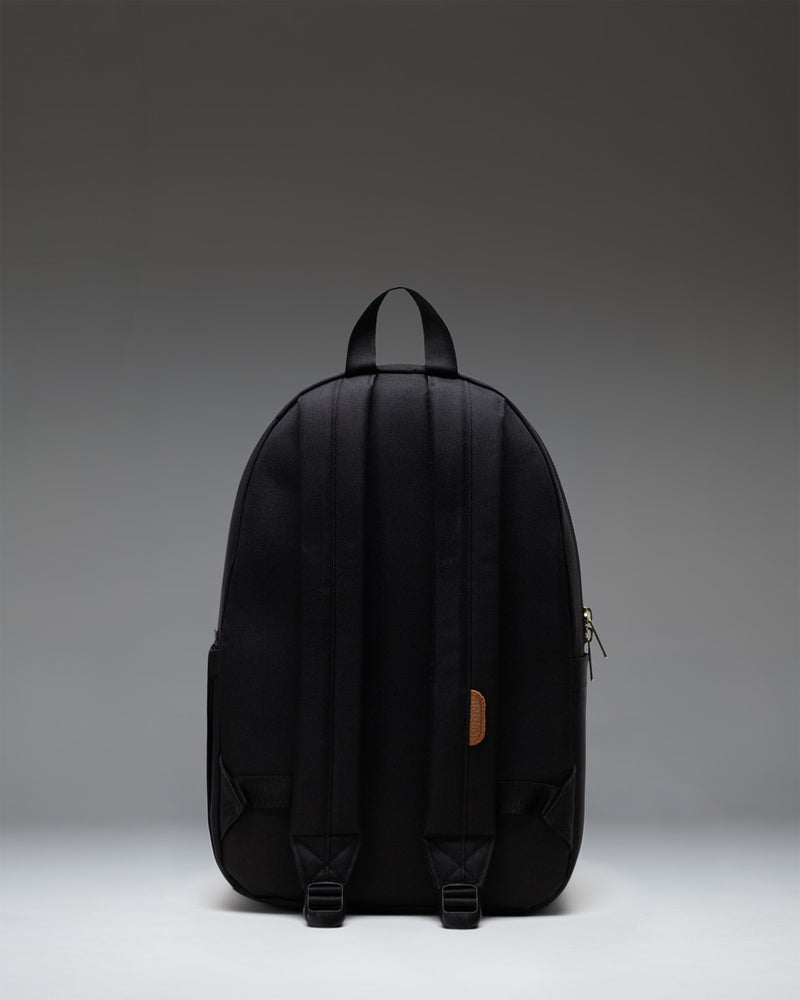 Herschel Supply Co. Settlement Backpack in classic black, showing a clean front view with the signature woven label and exposed zippers.