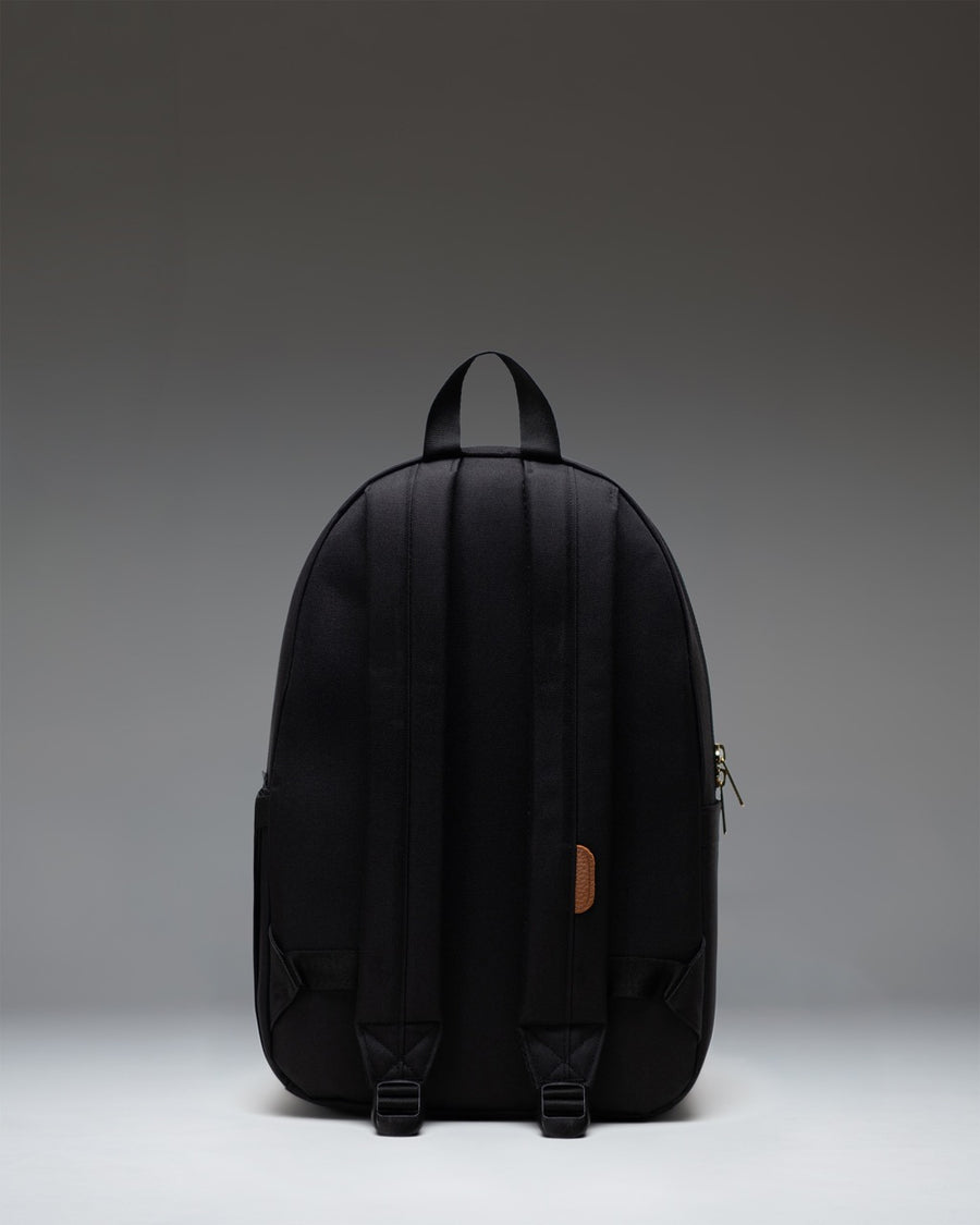 Herschel Supply Co. Settlement Backpack in classic black, showing a clean front view with the signature woven label and exposed zippers.