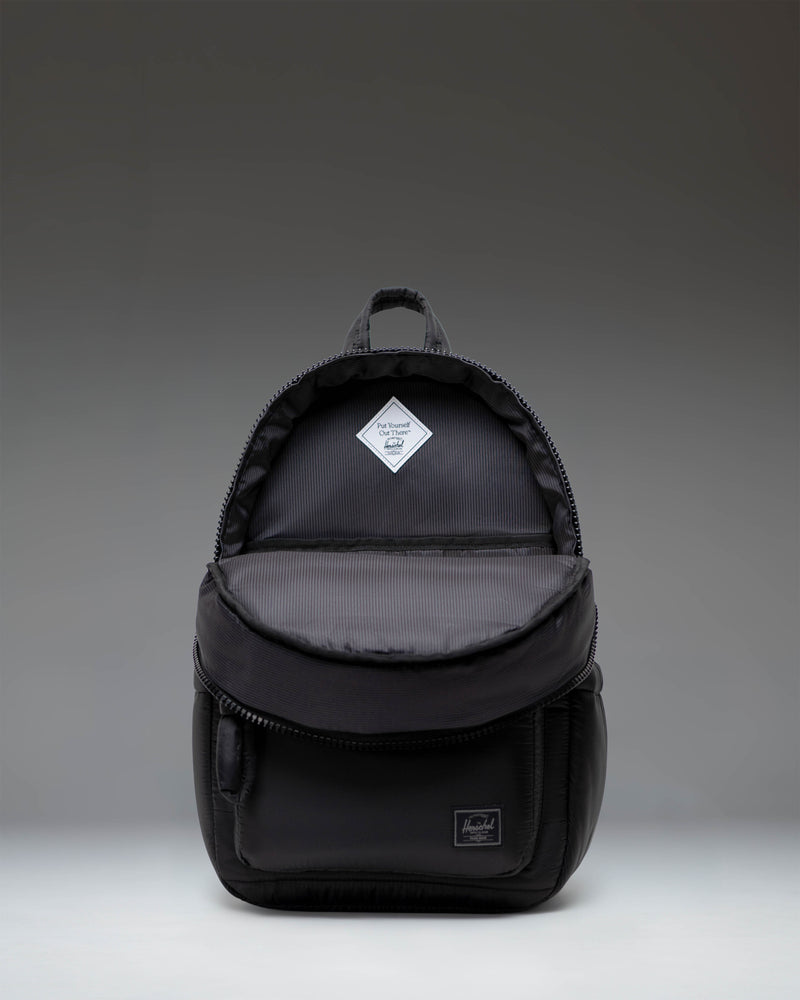 Herschel Supply Co. Settlement Backpack in classic black, featuring a front storage pocket, exposed zippers, and the signature woven label.