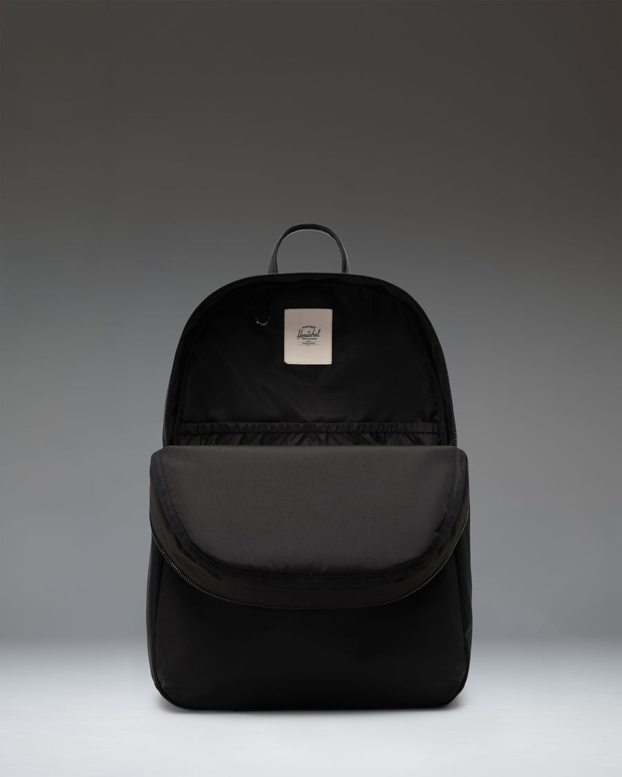 Herschel Supply Co. Beatrix Backpack in solid black, featuring a classic zippered main compartment and front storage pocket.