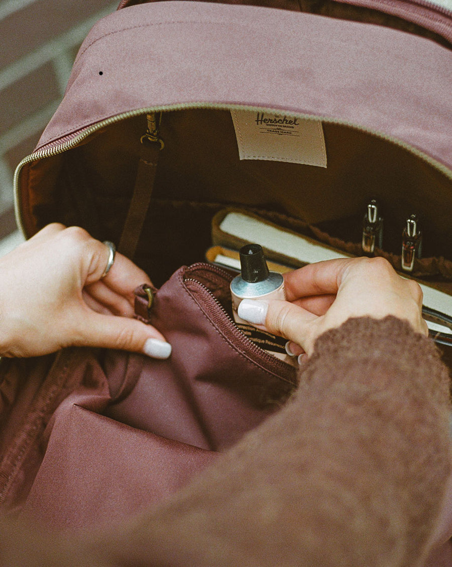 Herschel Supply Co. Beatrix Backpack in Black shown from the front with smooth webbing details and a metal logo.