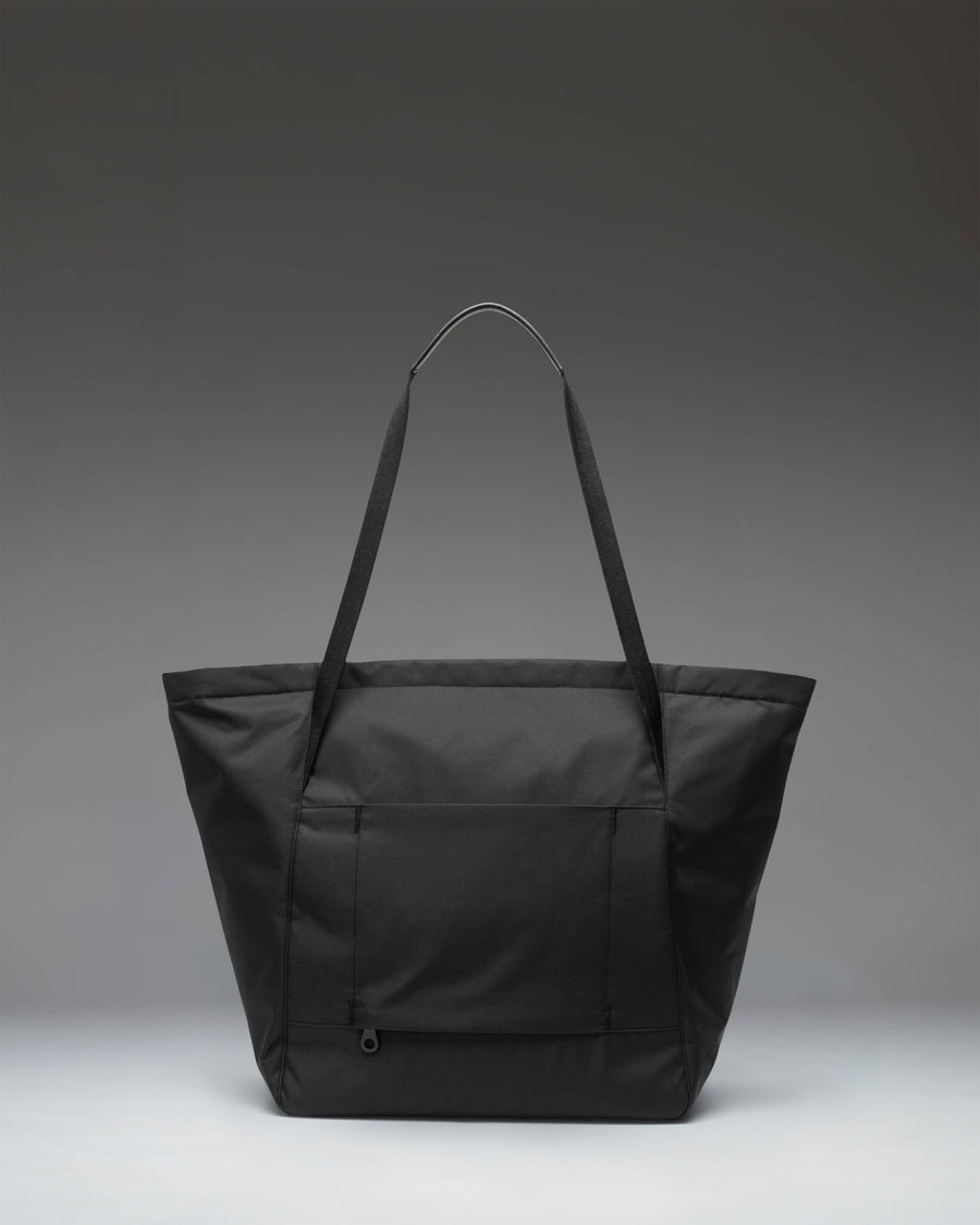 Herschel Supply Co. Joana Tote in black featuring structured recycled twill fabric, a front zippered pocket, and dual shoulder straps.